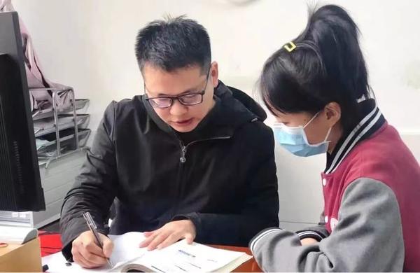 河南省骨干教师黄沐正在给学生做课后辅导